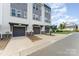 Beautiful exterior view of townhomes featuring private garages and well-maintained lawns at 223 S Bruns Ave, Charlotte, NC 28208