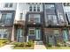 Close-up of townhome exteriors featuring brick accents, individual balconies, and quaint front yards at 223 S Bruns Ave, Charlotte, NC 28208