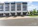 Charming townhouse complex featuring multi-level facade, modern design, and individual car garages at 223 S Bruns Ave, Charlotte, NC 28208