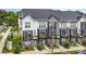 Desirable townhome showcasing stylish architecture, a charming balcony, and inviting curb appeal at 223 S Bruns Ave, Charlotte, NC 28208