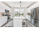 Bright kitchen featuring white cabinetry, stainless steel appliances, and a central island at 223 S Bruns Ave, Charlotte, NC 28208