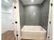 Bathroom featuring a tiled shower and a door to a walk-in closet at 2330 Neill Rd, Lancaster, SC 29720