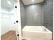 Stylish tub with gray subway tile and access to a walk in closet at 2330 Neill Rd, Lancaster, SC 29720