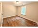 Bedroom with sleek wood-look floors and bright window at 2330 Neill Rd, Lancaster, SC 29720