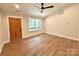 Bright, spacious bedroom featuring a modern ceiling fan, light wood-look floors and a traditional wood door at 2330 Neill Rd, Lancaster, SC 29720