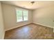 Clean bedroom with a large window showcasing outdoor views and wood flooring at 2330 Neill Rd, Lancaster, SC 29720