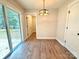 Dining area with wood floors, a modern light, and a sliding glass door to the deck at 2330 Neill Rd, Lancaster, SC 29720