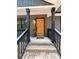 Inviting front entrance with a light wood door, black trim, and brick steps to covered porch at 2330 Neill Rd, Lancaster, SC 29720