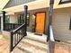 Inviting front entrance with a light wood door, black trim, and brick steps to covered porch at 2330 Neill Rd, Lancaster, SC 29720