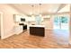 Bright, open kitchen features white cabinetry, stainless appliances, island, and sliding door to backyard at 2330 Neill Rd, Lancaster, SC 29720