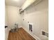 Small laundry room with wood-look flooring and a wire rack for storage at 2330 Neill Rd, Lancaster, SC 29720