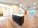Open-concept living area features a kitchen island, ceiling fan, and wood-look flooring at 2330 Neill Rd, Lancaster, SC 29720