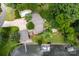 Overhead view of the property, showcasing the house, pool, boat dock, spacious driveway and lush greenery at 24756 Strand Dr, Albemarle, NC 28001