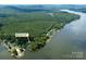 Aerial view of the property at 24756 Strand Dr, Albemarle, NC, nestled on the lake with lush trees at 24756 Strand Dr, Albemarle, NC 28001