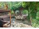 Backyard patio featuring brick staircase and arches, mature vines and outdoor seating area at 24756 Strand Dr, Albemarle, NC 28001