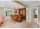 Elegant home bar featuring a marble countertop, custom cabinetry, and pendant lighting in a spacious entertaining area at 24756 Strand Dr, Albemarle, NC 28001