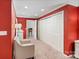Bedroom with red walls, carpet, an upholstered chair, and a closet at 24756 Strand Dr, Albemarle, NC 28001