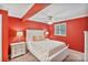 Cozy bedroom featuring red walls, carpet, and a white bed frame and side tables at 24756 Strand Dr, Albemarle, NC 28001