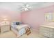 Bedroom with plush carpeting, ceiling fan, and soft pink paint at 24756 Strand Dr, Albemarle, NC 28001