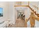 Inviting hallway with tiled floors, staircase, and neutral paint, leading to comfortable and stylish living spaces at 24756 Strand Dr, Albemarle, NC 28001