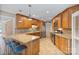 Spacious kitchen featuring granite countertops, custom cabinets, stainless steel appliances, and breakfast bar seating at 24756 Strand Dr, Albemarle, NC 28001