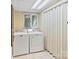 Laundry room equipped with a washer, dryer, and ample storage space at 24756 Strand Dr, Albemarle, NC 28001