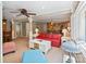 Bright living room featuring a red sofa, ceiling fan, and natural light at 24756 Strand Dr, Albemarle, NC 28001