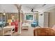 Comfortable living room featuring a red sofa, ceiling fan, large windows, and a tranquil atmosphere at 24756 Strand Dr, Albemarle, NC 28001