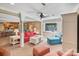 Inviting living room with a red sofa, ceiling fan, neutral walls, and a view of the kitchen at 24756 Strand Dr, Albemarle, NC 28001