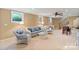 Inviting living room with plush seating, ceiling fan, and ample natural light at 24756 Strand Dr, Albemarle, NC 28001