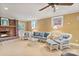 Comfortable living room showcasing a brick fireplace and wicker furniture at 24756 Strand Dr, Albemarle, NC 28001