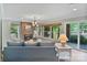 Inviting living room features a brick fireplace and large windows showcasing scenic views at 24756 Strand Dr, Albemarle, NC 28001