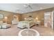 Spacious main bedroom with neutral carpet, ceiling fans, ample natural light, and comfortable furnishings at 24756 Strand Dr, Albemarle, NC 28001