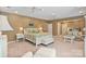 Large main bedroom featuring a sitting area, carpeted floors, ceiling fans, and a serene ambiance at 24756 Strand Dr, Albemarle, NC 28001