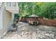 Relaxing patio with outdoor seating, a brick wall, and lush greenery at 24756 Strand Dr, Albemarle, NC 28001