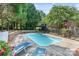 Inviting outdoor pool area with lounge chairs, surrounded by mature trees and a private, tranquil setting at 24756 Strand Dr, Albemarle, NC 28001