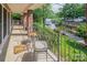Inviting covered porch overlooking a tranquil lake, featuring comfortable seating and stunning waterfront views at 24756 Strand Dr, Albemarle, NC 28001
