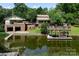 Beautiful waterfront home featuring a dock and multi-car garage, surrounded by lush landscaping and serene water views at 24756 Strand Dr, Albemarle, NC 28001