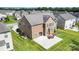 Aerial view of the backyard featuring a large patio and well-maintained lawn at 2577 Shoal Park Rd, Concord, NC 28027