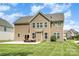 Large backyard with patio, outdoor seating, and mature landscaping, perfect for outdoor activities at 2577 Shoal Park Rd, Concord, NC 28027