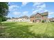Expansive backyard featuring a well-manicured lawn and patio with outdoor seating, perfect for entertaining at 2577 Shoal Park Rd, Concord, NC 28027