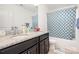 Bathroom with granite counters, dual sinks, and a shower/tub with blue tile at 2577 Shoal Park Rd, Concord, NC 28027
