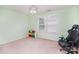 Bright bedroom with neutral walls, ceiling fan, and a view to the backyard at 2577 Shoal Park Rd, Concord, NC 28027