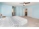 Spacious light blue bedroom features a ceiling fan and many doors at 2577 Shoal Park Rd, Concord, NC 28027