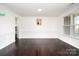 Formal dining room with wainscoting, chandelier, and hardwood floors, perfect for hosting elegant gatherings and dinners at 2577 Shoal Park Rd, Concord, NC 28027