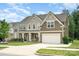 Attractive home featuring a well-manicured lawn, covered front porch, and an attached two-car garage at 2577 Shoal Park Rd, Concord, NC 28027
