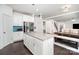 Open concept kitchen with stainless steel appliances, island with granite countertops and a seamless flow to the dining area at 2577 Shoal Park Rd, Concord, NC 28027