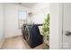 Bright laundry room with front load machines and a wire shelf at 2577 Shoal Park Rd, Concord, NC 28027