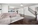 Spacious living room with hardwood floors, large sectional sofa, and open floor plan to the kitchen at 2577 Shoal Park Rd, Concord, NC 28027