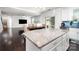 Bright, open-concept living space with kitchen island and sliding doors to backyard, seamlessly blending indoor and outdoor living at 2577 Shoal Park Rd, Concord, NC 28027